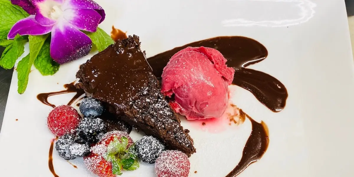 Flourless Chocolate Torte with Chocolate Ganache & Raspberry Coulis at Papillon Restaurant