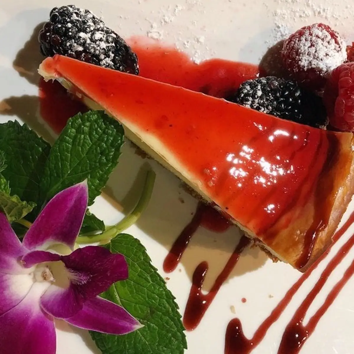 Papillon Housemade Cheesecake with Seasonal Fruit Coulis at Papillon Restaurant
